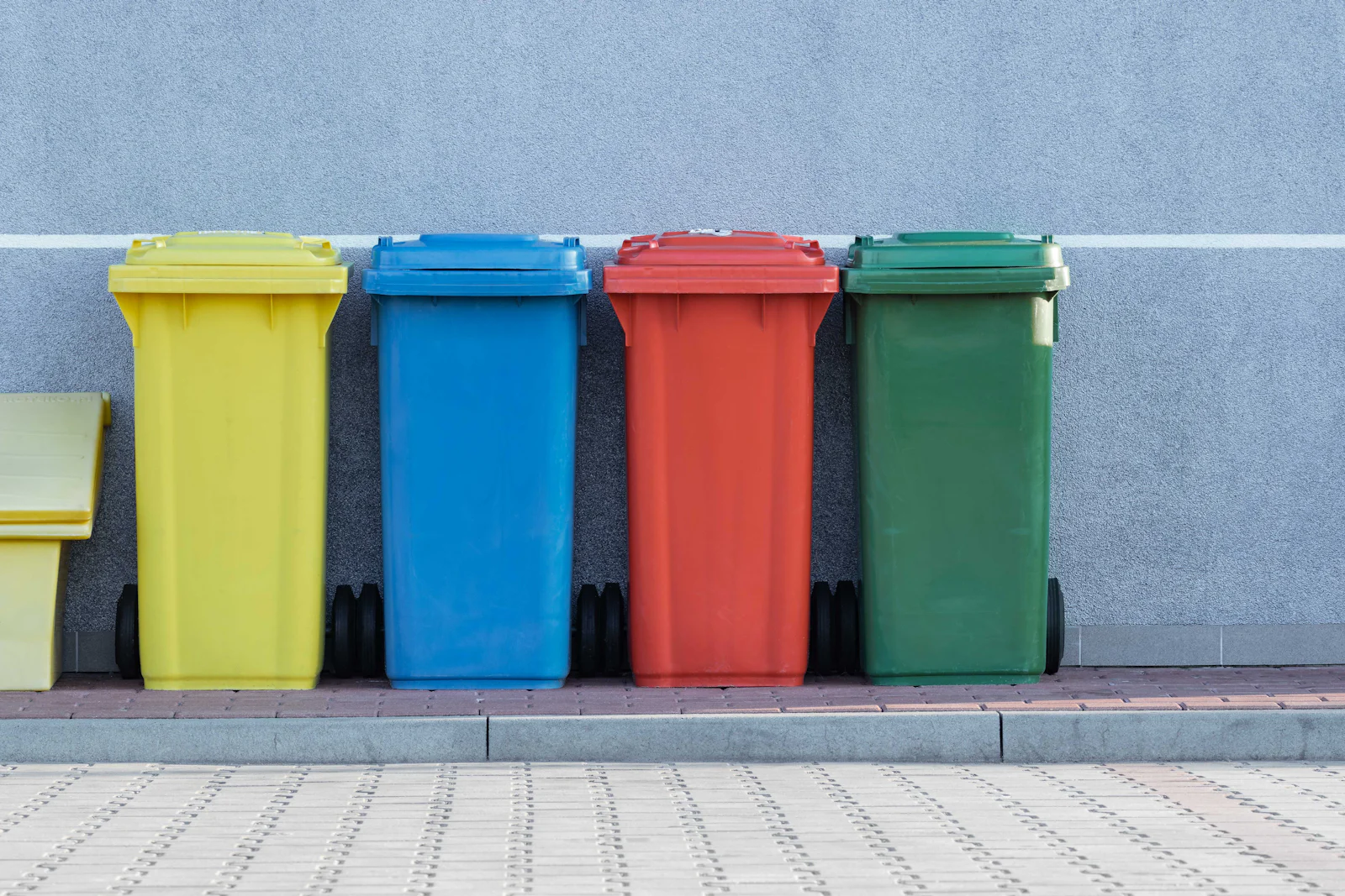 Colour-coded waste bins lined up for separated collection