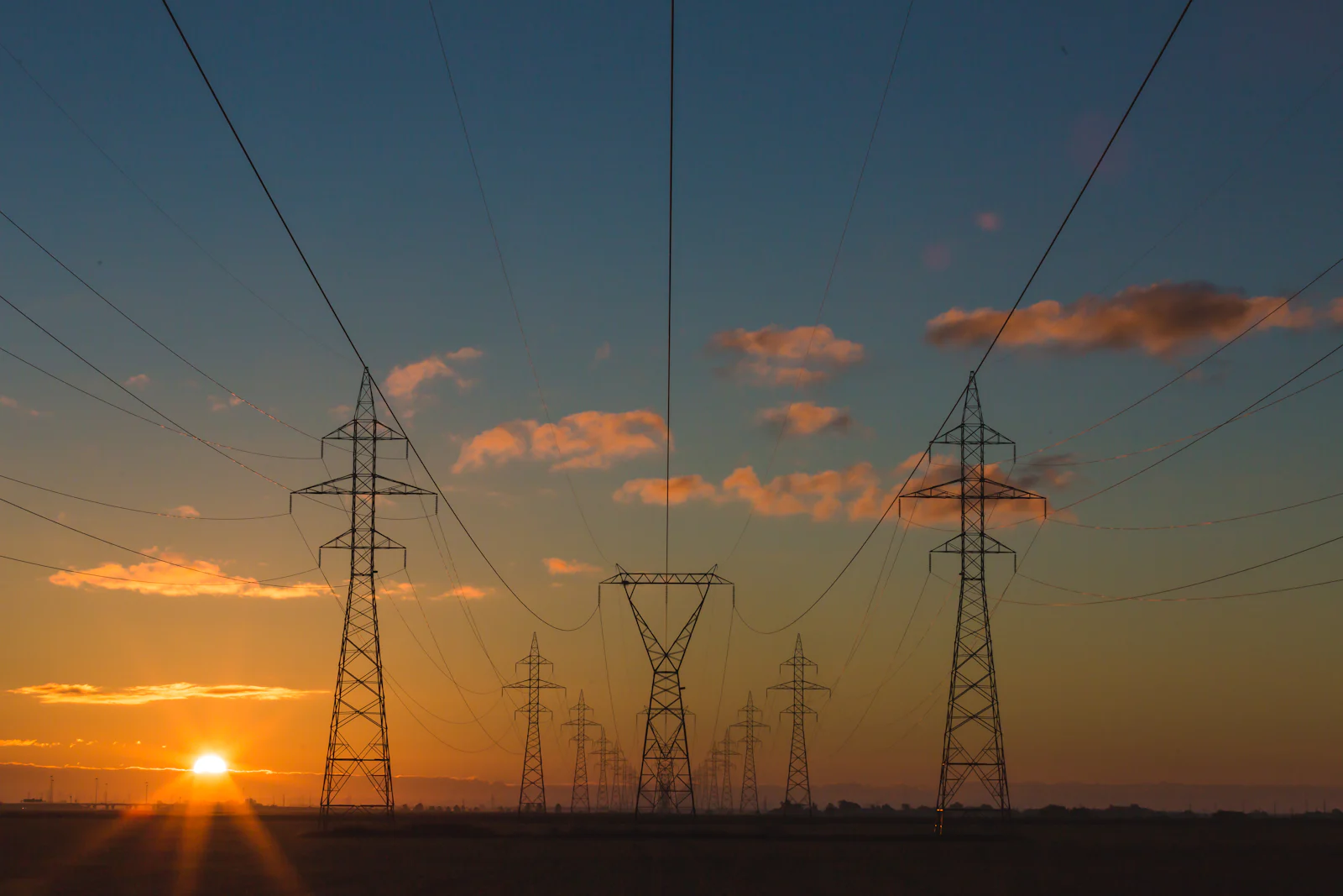 Electricity transmission towers at sunset
