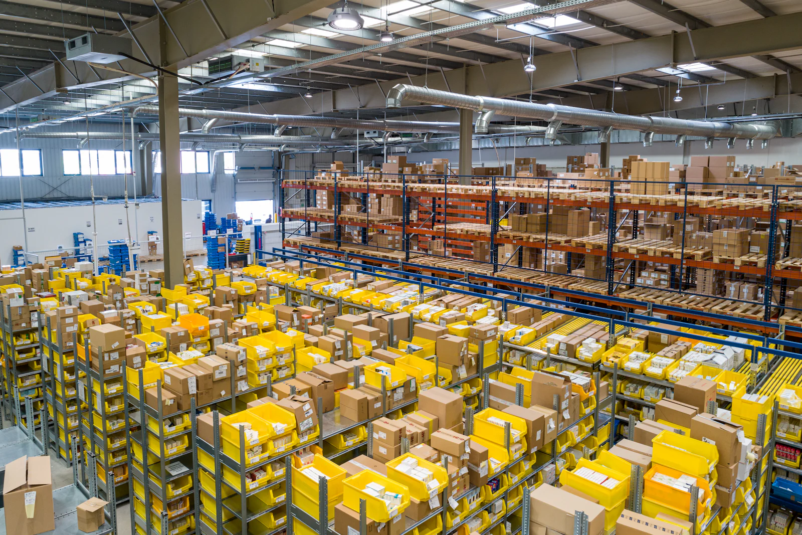 Busy warehouse floor with stacked consignments